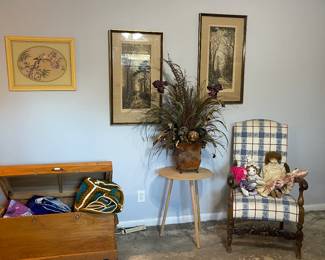 Trunk, floral arrangement and stuffed chair along with an antique doll and assorted wall art