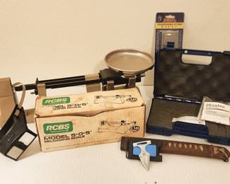 precision scales, jeweler's glasses, gun case, belt-buckle dagger, leather sheath and sharpening stone