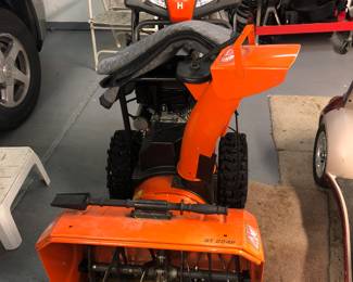 FULL VIEW OF THIS BRAND NEW COMMERCIAL SIZE SNOWBLOWER WITH HEADLIGHTS.