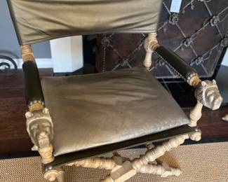 Chairs have carved animal heads on the arms