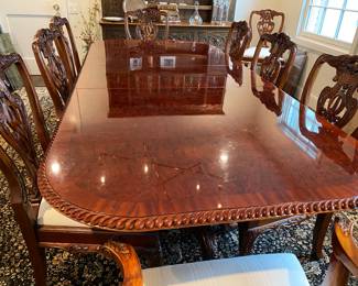 Now $1500 - Was $3000 Carved Chippendale-style Mahogany dining table with 10 carved chairs                                                                                               table: 77" long plus two 18.5" leaves = total length 114"                             