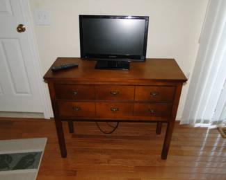 TV is also for sale that sits atop this amazing mission style storage piece