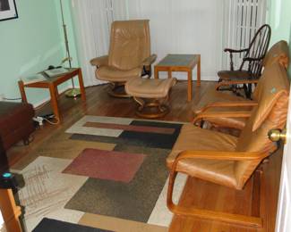 The den is filled with lots of great furniture and rugs