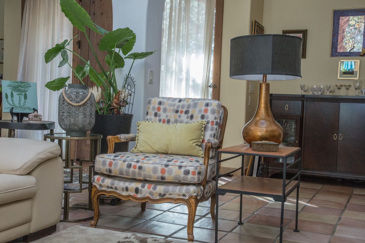 left to right: Beautiful French upholstered arm chair. Perfect for your sitting room: $280.00. MCM metal and wood side table (22.5"h x 16"w x 24"d): $98.00. Bronze/gold glaze table lamp with cloth lamp shade and finial: $140.00