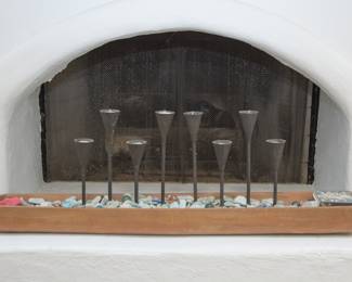 Iron candle sticks. Two groups of 4 inside a wooden boat.  Rocks and veg. marbles included inside.  $58.00