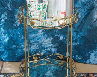 Gilt bar cart w/casters and mirrored shelves (33"h slo handle (33.3"h to handle, 28"h to top of cart):  $80.00