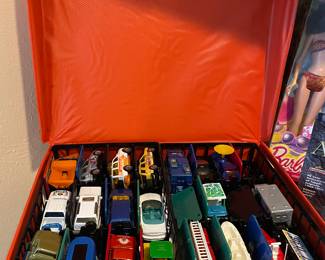 Two rows deep of die cast cars in vintage carry case