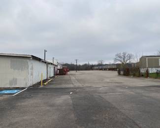 Continue forward to the left you will see the warehouse. Make a left at the corner. 