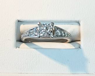 0.71 ct tw center princess cut diamond
 VS2 (E)
0.50 ct tw in diamonds on the setting. 14k white gold. Sz 5.5