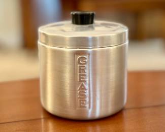 Aluminum grease can with internal crumb filter.