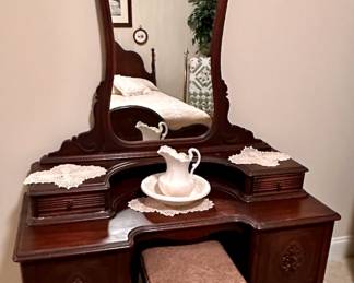 Antique mirrored vanity and bench.