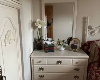 white chest of drawers and attached mirror