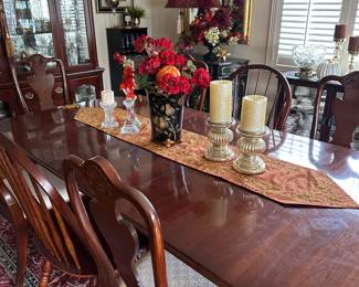 Cherry wood dining table with 3 leafs, table pads, 4 matching chairs, 2 arm chairs; also available as shown here with 2 additional coordinating chairs (seating for 8)