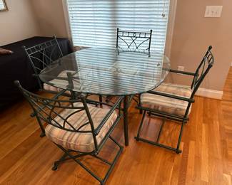 M84 - $125. Glass top table with 4 chairs. Table measures 48" across. 