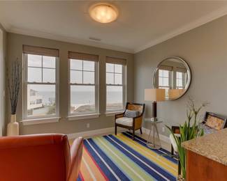 ONLY available in this photo: Barclay Butler multi-color rug, 2 Vintage Pier 1 Imports woven back lounge chairs, Ethan Allen round mirror 