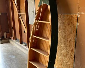 Cute canoe shelf for a child’s bookshelf or to display toys or other items. 