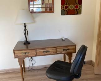 Small desk with office chair. Twisted wire base lamp with white shade