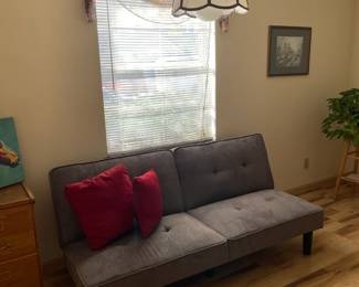 Mid century modern couch in dove gray that folds flat into a bed. Great item for a small apartment or dorm room.
