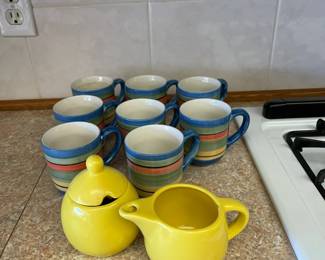 Matching coffee mugs and sugar and creamer set