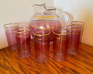 Cranberry and gold kool-aide style pitcher with six glasses. Pristine condition