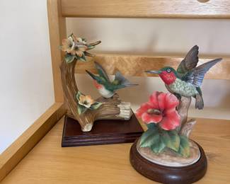 Hummingbird figurines on wooden bases