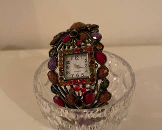 Women’s jewel tone encrusted bracelet watch. 