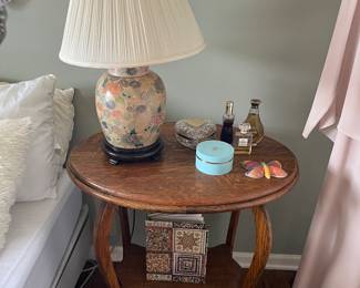 Vintage accent/side table; vintage pottery table lamp with wood base; selection of perfume bottles.