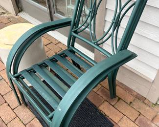 Four matching metal patio chairs (two shown here, and two shown in the following photo).