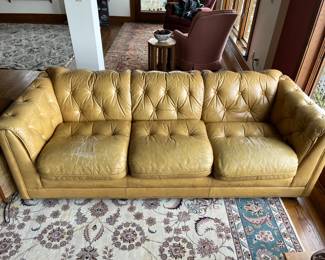 Vintage three-seat tufted leather couch.