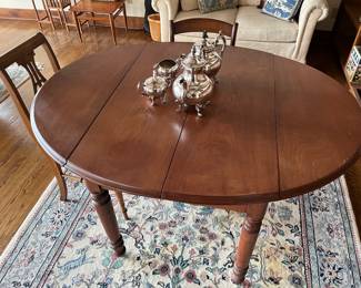 Vintage drop-leaf table; four-piece silverplate tea set.