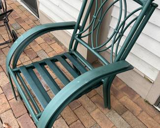 Four matching metal patio chairs (two shown here, and two shown in the following photo).