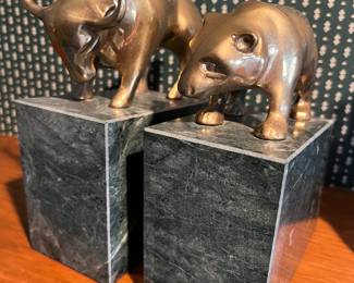 Vintage heavy brass bull and bear bookends with green granite bases.