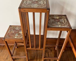 Interesting three-tiered wood stand with tile surfaces.