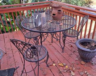 Wrought iron patio set, table and four chairs