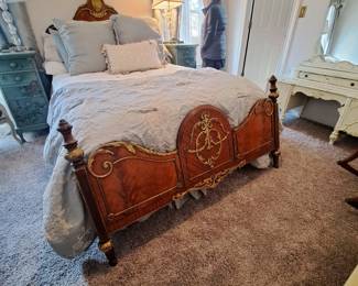French bed with metal scrolling and accents overlaying veneers