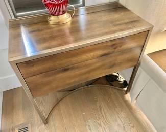 $650 - Caracole nightstand #1 - 29.5" H, 33" W, 18" D - Made from fumed cluster oak featuring two touch-latch drawers and a top that flips up to reveal an outlet. Concealed light on nightstand's underside.