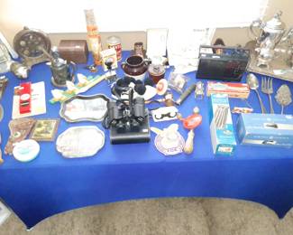 This table is full of a lot of little antique and vintage items.