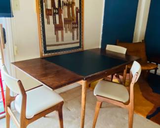 fabulous midcentury leather and walnut table with extension leaves that store under leather top