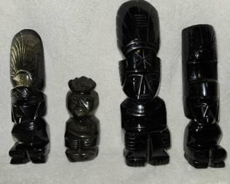 4 Obsidian tiki carvings