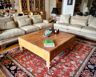 2 off-white Bernhardt sofas with wood trim and over-sized coffee table
