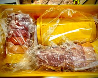 Full, unused tupperware container filled with smaller Tupperware pieces - in original plastic