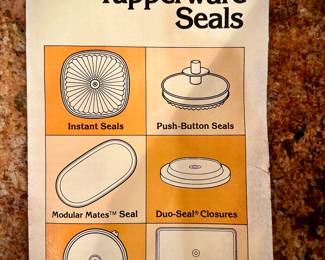 Full, unused tupperware container filled with smaller Tupperware pieces - in original plastic