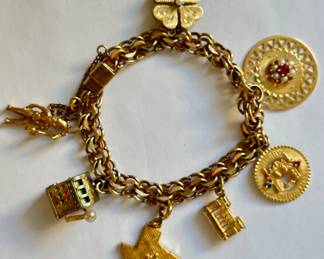 Vintage 18 Karat Gold Rhythm Jewelry Charm Bracelet With 7 Charms: Charms Mostly 14 Karat Gold Or Sterling
Lot #: 38