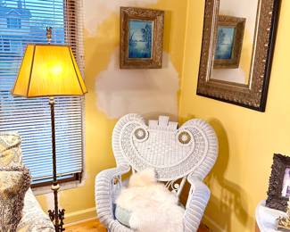 Vintage white Victorian style wicker rocker.