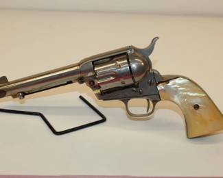Colt Single Action Army Revolver, 1st Generation Colt Single Action Army Revolver manufactured in 1921, nickel plated with mother of pearl grips. Strong crisp action, cylinder rotates great but misses on occasion (worn hand) Great old cowboy gun with great eye appeal,  worthy of a factory letter!! 38 WCF ser# 341598   **ATF LAWS APPLY**