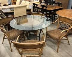 Black wrought iron and glass table with rattan chairs