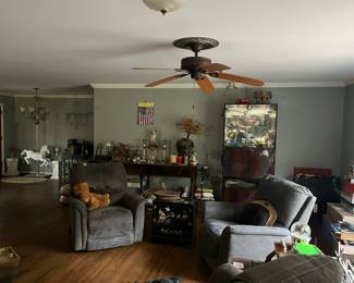 Room with two recliners, and all types of home decor