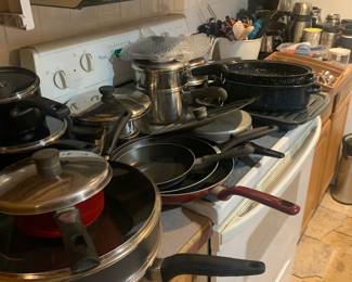 Pots and pans silverware coffee mugs coffee pot stove and refridgerator