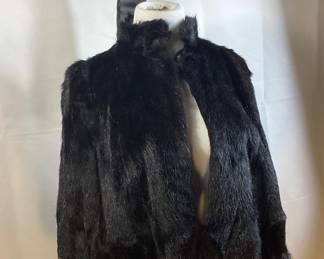 BIH517 1930's Black Fur Cape Style Jacket W/ Hat	Unknown fur type please see pictures. The approximate measurements from shoulder to shoulder are 17". The length from back collar is approximately 30".
