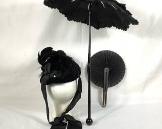 BIHY224 1800’s Mourning Attire	Parasol black umbrella, handle does fold for easier carry. Does have some rips in the umbrella. Antique Victorian black folding fan. 1870's-1885 Mourning hat, Ostrich plume on velvet. Black glass beads and hexagon attachments.
